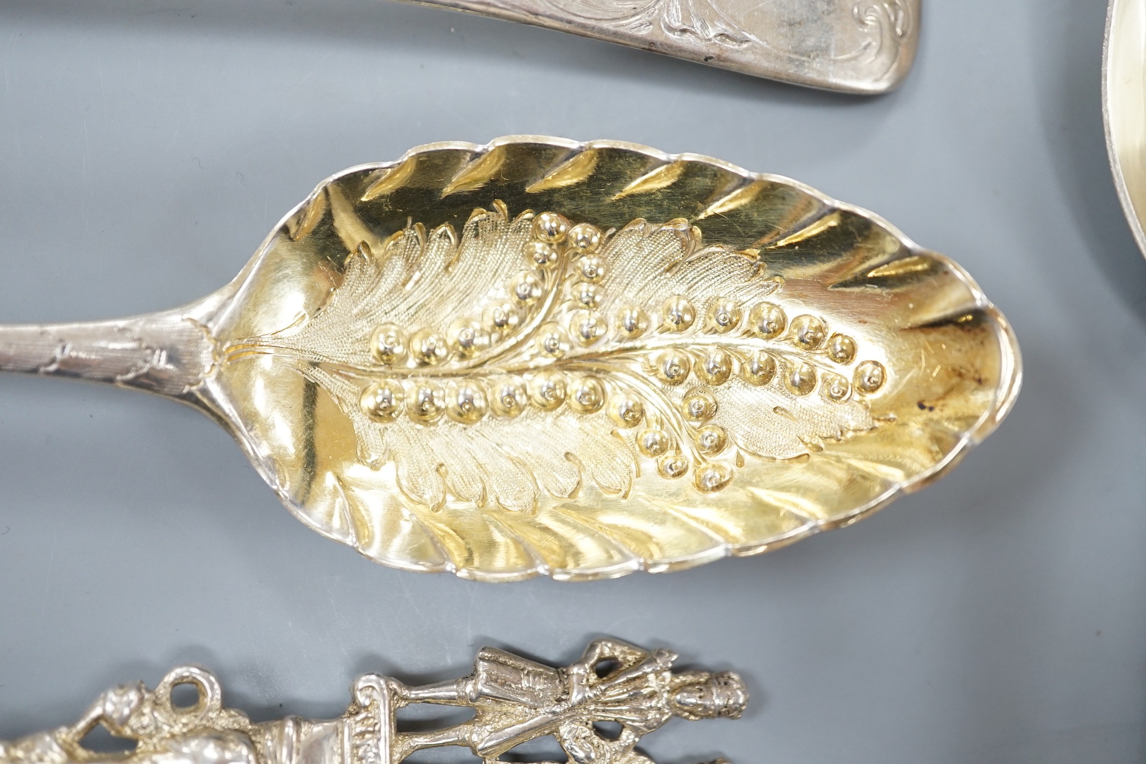 Two George III silver 'berry spoons', a pair of Victorian silver apostle serving spoons, Josiah Williams & Co, London, 1888, 19.8cm and a continental white metal spoon.